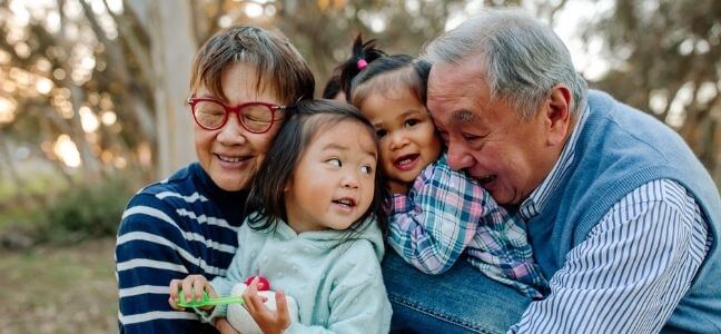 A photo of a couple looking at each other in their retirement years